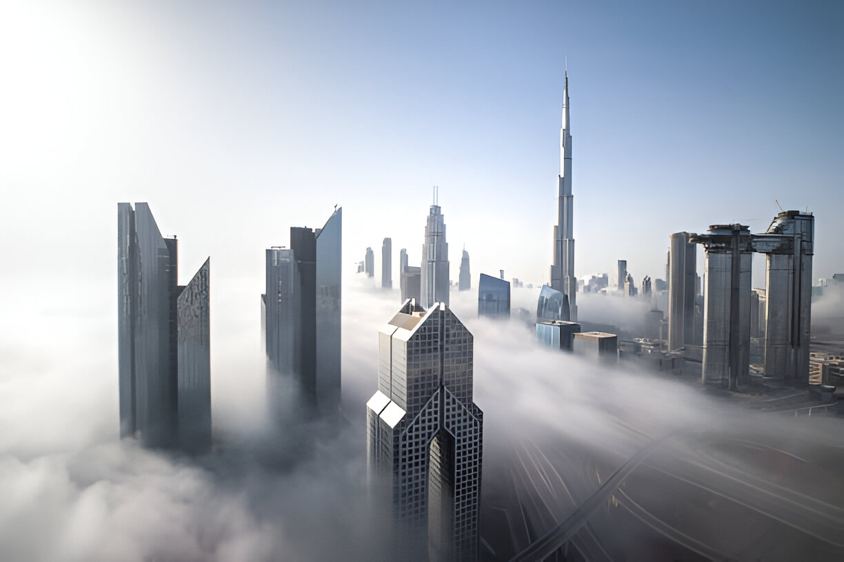 A foggy skyline where glass buildings dissolve into clouds